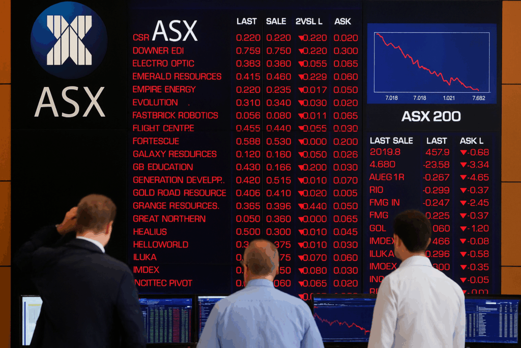 Traders monitor ASX stock market screens as technology stocks lead declines